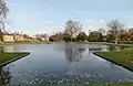 Upper pond looking towards the NPL. The Victorian Mews is on the left and Upper Lodge centre left. The tops of the alcoves are visible to either side of the gap where the Upper pond flows over the cascade