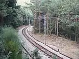 Line C-9 passing through pine forest below Siete Picos