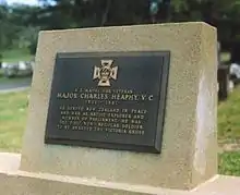 colour photograph of a plaque mounted to a headstone