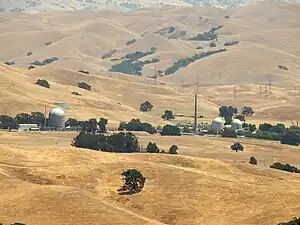 Landscape of Vallecitos Nuclear Center set in golden fields with scattered trees