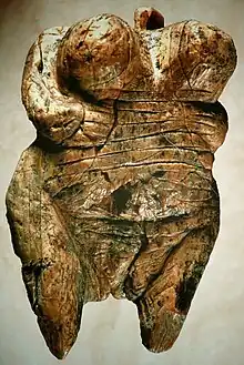 Carving of a female human torso with pronounced breasts (from Human history)