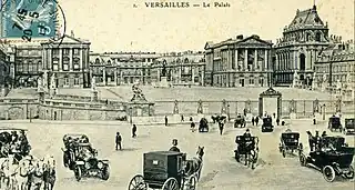 Place d'Armes in the early 20th century. Horse-drawn carriages and automobiles cross paths