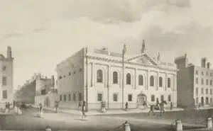 Neoclassical facade of the Royal College of Surgeons in Ireland with people walking