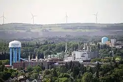 View of Virginia, showing a water tower and a line of wind turbines in the distance