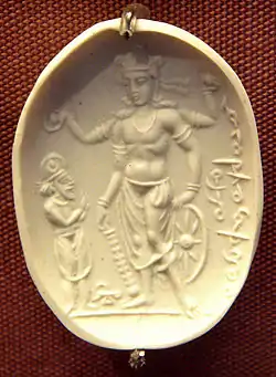 Vishnu Nicolo Seal representing Vishnu with a worshipper (probably Mihirakula), 4th–6th century CE. The inscription in cursive Bactrian reads: "Mihira, Vishnu and Shiva". British Museum.