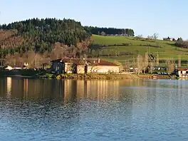 lake with house near a mountain