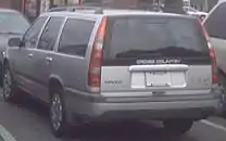 Rear view of silver V70 XC with black 'Cross Country' decal on the tailgate