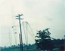 Three transmitter towers, with one bent in half