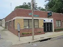 A one-story brick building on a street corner