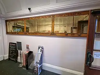 Bronze plaques with names embossed, fixed to a wall