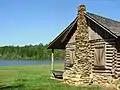 A relocated log cabin stands on the grounds of SUSCC.