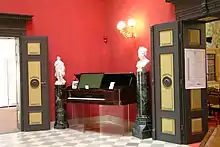 Restored lobby, showing the combined "composition piano" and writing desk specially made by Bechstein for Wagner, with a large music stand and space for papers