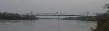 A graceful truss bridge over a broad river.