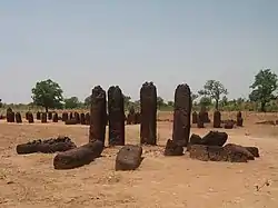 Image 1The Senegambian stone circles (Wassu section) believed by archaeologists and historians to be built by the Serer people of the Senegambia region. The Senegambia stone circles are the largest concentration of stone circles seen anywhere in the world according to UNESCO. They are sacred burial grounds and a place of ritual offerings (kuur in Serer).Credits: Sarang, AnonMoos, (and Yoonir file by Tamsier)For more about the pentagram in Serer spirituality, see Yoonir in Serer religion and Serer creation myth.