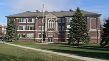 Three-story brick building with vaguely neoclassical details