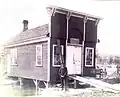 Herbert Radley stands in front of the original building, a carpentry shop, which was built in 1898 over the mill race of the Crystal River so the current could generate power.  The shop was moved across the road around 1901, was painted white, and became the General Store - Then known as The Rural Store.