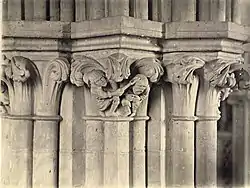 Detail of column capital sculpture, showing a farmer hitting a fruit thief Wells Cathedral