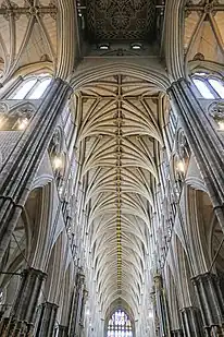 The inside of Westminster Abbey's nave, with a high vaulted ceiling.