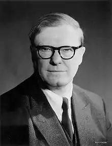 Head and shoulders of a man in suit and tie