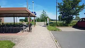 Covered bicycle racks and steps leading up a platform