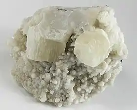 Two sharp pseudohexagonal crystals of witherite on calcite from Hardin County, Illinois (size: 6.4 × 5.4 × 3.4 cm)