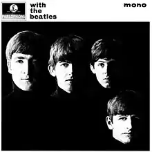 A black-and-white photograph of the Beatles' faces on a black background with the band members wearing black turtleneck sweaters