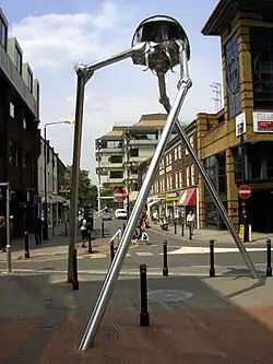 Image 52Statue of a tripod from The War of the Worlds in Woking, England, the hometown of author H. G. Wells. The book is a seminal depiction of a conflict between mankind and an extraterrestrial race. (from Culture of the United Kingdom)