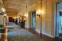 An ornate hallway with green rugs