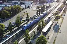 Aerial shot of a pågatågen train in Skånetrafiken purple livery taken in Skurup.