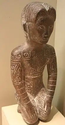 Statue of a man with Yue-style short hair and tribal body tattoos, from the state of Yue among the non-Chinese Baiyue peoples of southern China and north Vietnam.