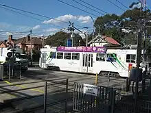 A Z-Class tram crossing the tram-train level crossing at Kooyong Station.