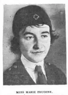 A young woman wearing a uniform cap with a cross symbol, and a jacket and necktie.