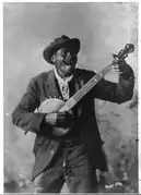 McCrary and Branson photograph of African-American banjo player "Happy John" Woods, date unknown; this image is reproduced on the cover of The Rough Guide to Blues Songsters (Library of Congress collection)